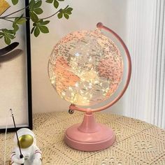a small globe with lights on it sitting on top of a table