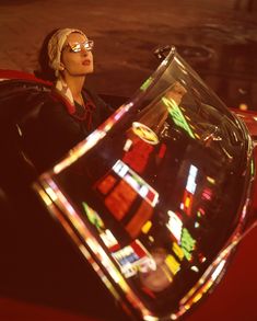 A woman driving a Ferrari in Milan, Italy, stares up at neon lights which can be seen reflected on her windshield, 1963. (📷 Ralph Crane/LIFE Picture Collection) #LIFEMagazine #LIFEArchive #Ferrari #NeonLights #Colorful #MilanItaly #1960s #RalphCrane