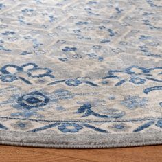 a blue and white rug on top of a wooden floor