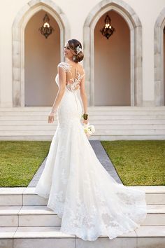 a woman in a wedding dress standing on steps