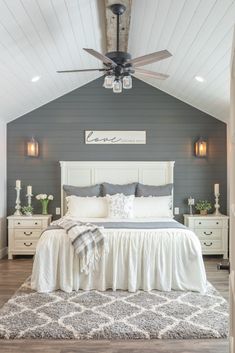 a bedroom with a bed, dressers and ceiling fan in the middle of it