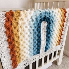 a crocheted blanket with the letter q on it