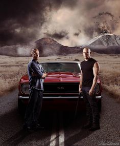 two men standing in front of a red car with the words fast and fabulous written on it
