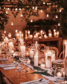 the table is set with candles and place settings