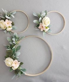 three hoop wreaths decorated with flowers and leaves