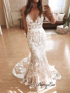 a woman is taking a selfie in her wedding dress while standing on the floor