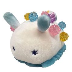 a white stuffed animal with multicolored hair
