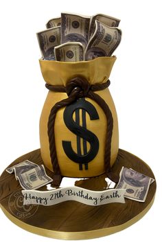 a birthday cake made to look like a money bag