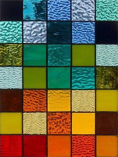 a multicolored stained glass window with different colors and patterns on it's sides