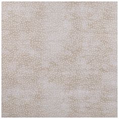 a beige and white rug with small dots on the ground, in front of a white background