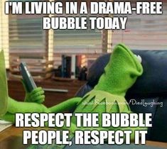 kermie the frog holding a cell phone while sitting on a couch with text that reads, i'm living in a drama - free bubble today