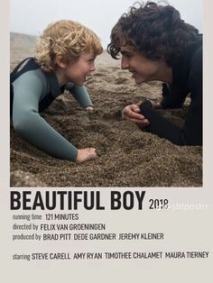 a movie poster with two people in the sand and one is looking at another person