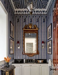 a bathroom with blue and white striped walls