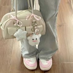 a person wearing pink shoes and holding a white purse