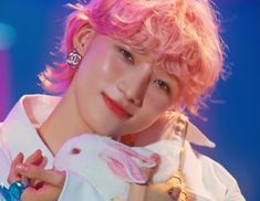 a person with pink hair holding a bunny