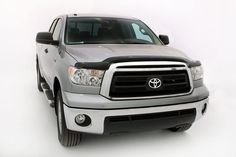 the front end of a silver truck on a white background