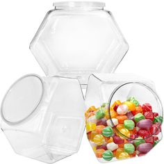 three clear containers with candy in them on a white background, one is filled with gummy bears