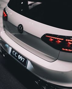 the back end of a white volkswagen car