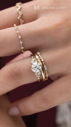 a woman's hand with two rings on it and the words snowdrift ring