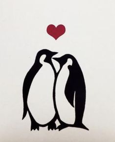 two penguins standing next to each other with a heart above them