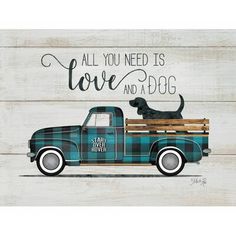 an old blue truck with a dog on the back is painted in black and white