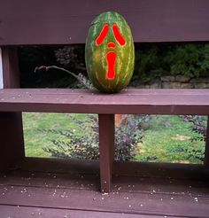 a watermelon carved to look like a hand and foot print on a bench