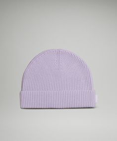 a light purple knitted beanie on a grey background