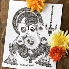 a drawing of an elephant on paper next to flowers