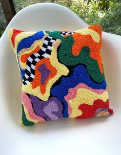 a multicolored pillow sitting on top of a couch