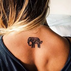 an elephant tattoo on the back of a woman's neck