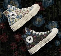 two converse shoes with floral print on them