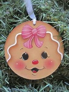 a wooden ornament with a pink bow on it's head and eyes