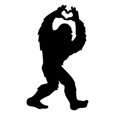a silhouette of a bigfoot with his hands in the shape of a heart