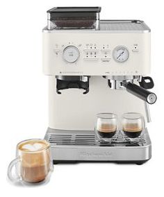 an espresso machine with two cups of coffee