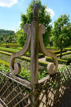 an old wooden fence in the middle of a garden