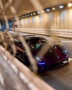 a purple sports car driving through a tunnel