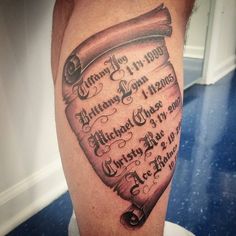 a man's leg with an old scroll tattoo on it and the words written in cursive writing