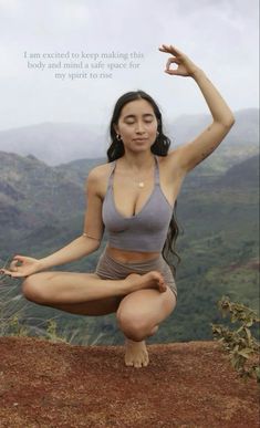 a woman is doing yoga on top of a mountain