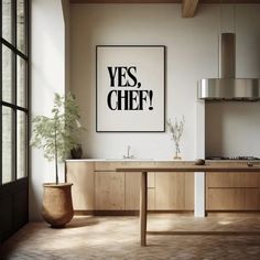 a kitchen with a large poster above the sink