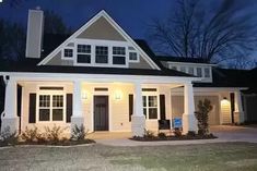 a white house with black shutters at night