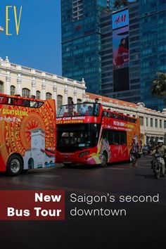 two red double decker buses parked next to each other in front of tall buildings with the words saigon's second bus tour down town