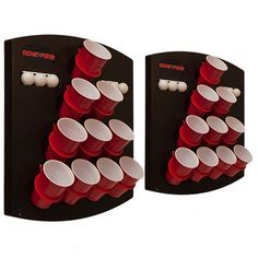 two red cups are on the back of a black and white wall mounted cup holder