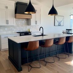 a kitchen with an island and bar stools