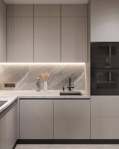 a modern kitchen with marble counter tops and white cabinets is lit by recessed lighting