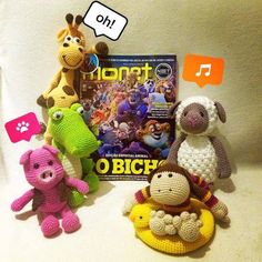 crocheted toys are sitting next to a book