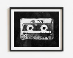 a black and white photo with an old fashioned cassette tape in front of it that says mix tape