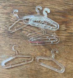 several metal clothes hangers on a wooden table