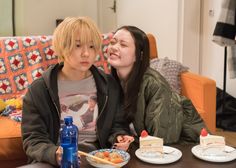 two young women sitting at a table with plates of food