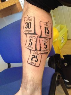 a man's leg with the date and year tattoos on it