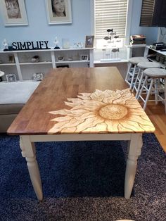 a wooden table sitting on top of a blue rug